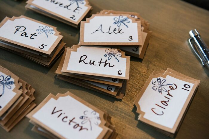 Wedding guests' name cards neatly arranged on a table.