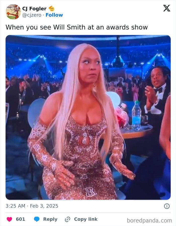 Woman in a sparkling dress reacting at the 2025 Grammys, seated at a table during the awards show.