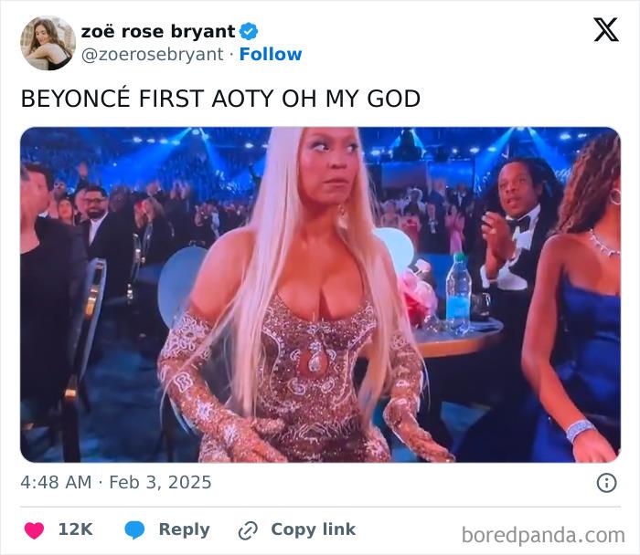 Person reacting with surprise in an elegant gown at the 2025 Grammys, with audience clapping in the background.