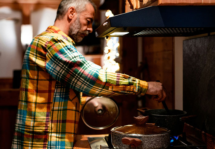Person wearing a colorful plaid shirt cooking, related to a funny prank enjoyed by the internet. Person wearing a colorful plaid shirt cooking, related to a funny prank enjoyed by the internet.