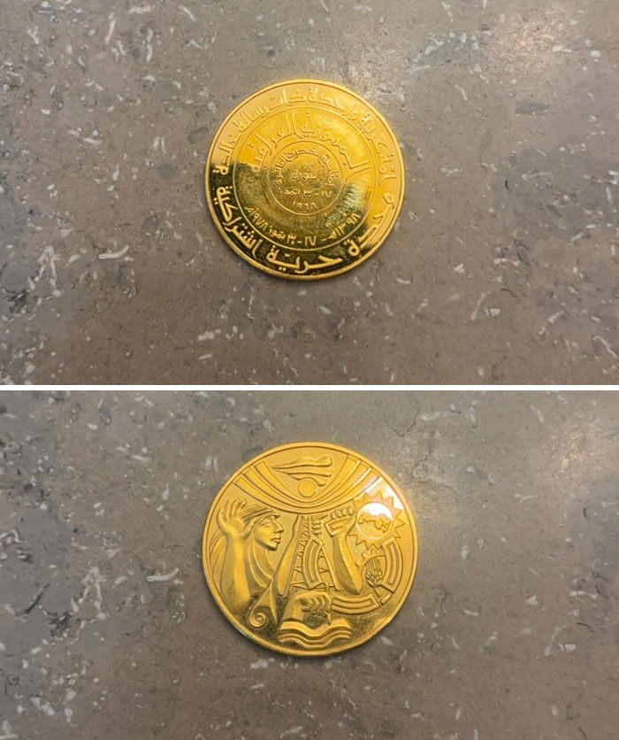 Cool-Old-Things: Antique gold coin with intricate engravings and design on a stone surface.