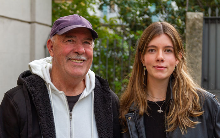 Older man with a younger woman outdoors, related to dad dating a younger girl.