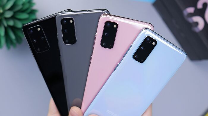 Four smartphones in different colors displayed, potential price hikes due to new tariffs.