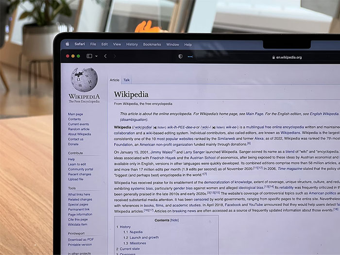 Laptop screen displaying a Wikipedia page viewed in a modern home setting, related to darkest stories found online.