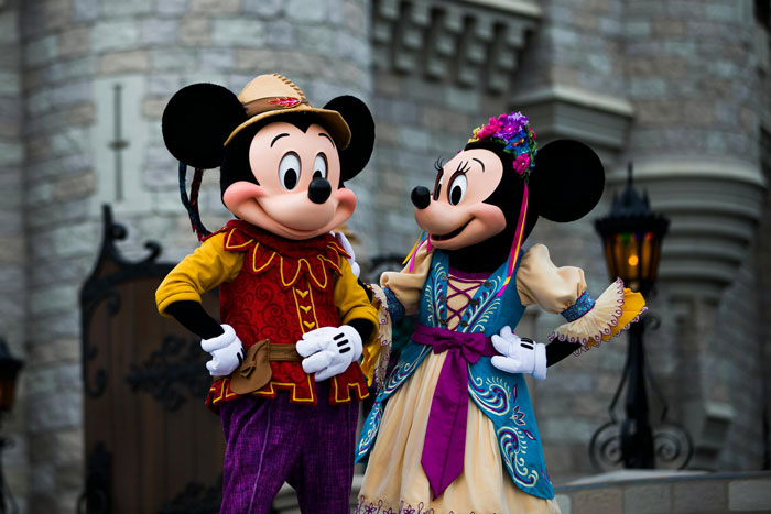 Mickey and Minnie Mouse in colorful outfits at Disneyland, representing a dream vacation setting. Mickey and Minnie Mouse in colorful outfits at Disneyland, representing a dream vacation setting.