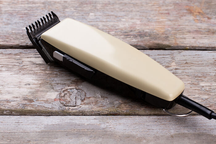 Electric hair clipper on a rustic wooden surface, illustrating a poor Valentine's Day gift choice.