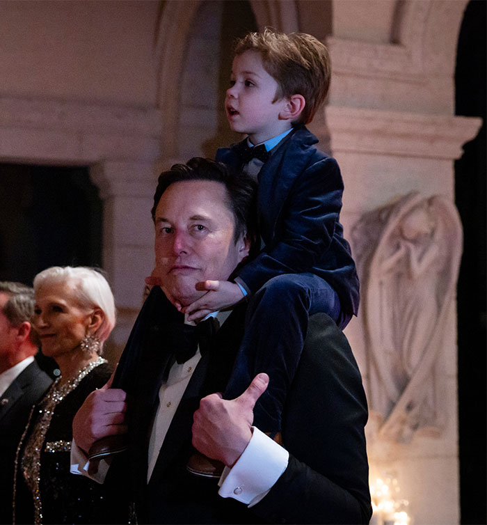 Elon Musk carrying son X