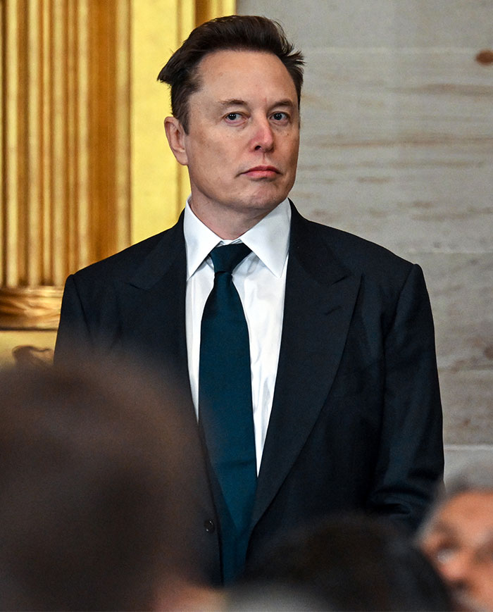Elon Musk wearing a black jacket at a public event.