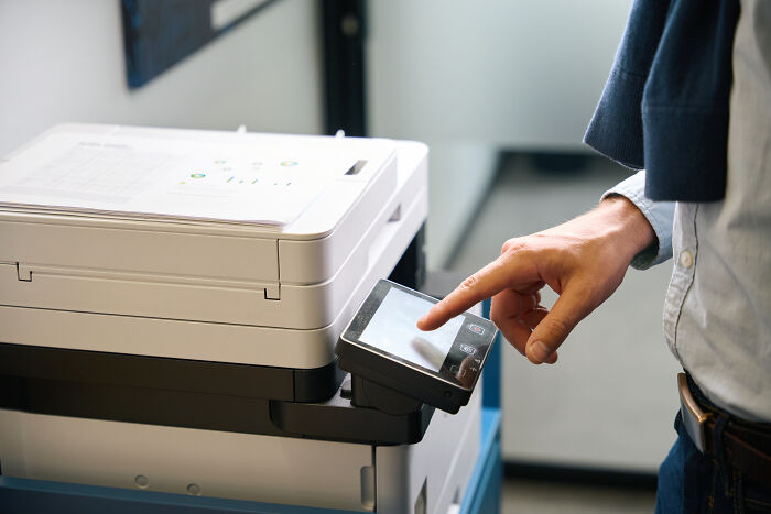 Person using a printer, an example of worst Valentine's Day gifts.