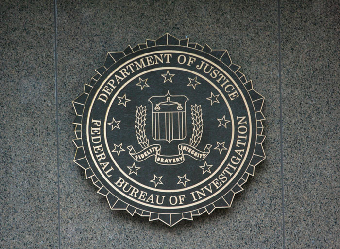 FBI emblem on a building wall, symbolizing an ongoing investigation related to an event. FBI emblem on a building wall, symbolizing an ongoing investigation related to an event.