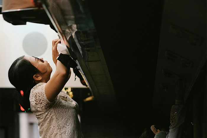 Passenger practicing flying etiquette by adjusting overhead compartment.