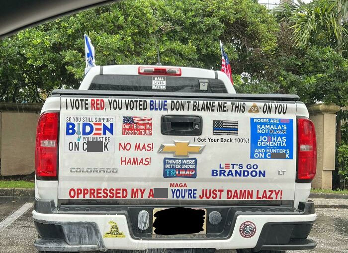Truck in Florida with political stickers, including pro-Trump and anti-Biden messages, showcasing diverse opinions.