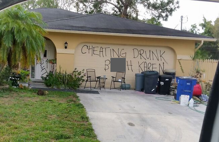Graffiti on a Florida house garage amidst a suburban setting, illustrating a dramatic wild moment.