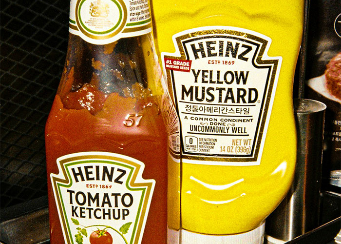 Heinz ketchup and mustard bottles, popular condiments among foods people started loving when they grew up.