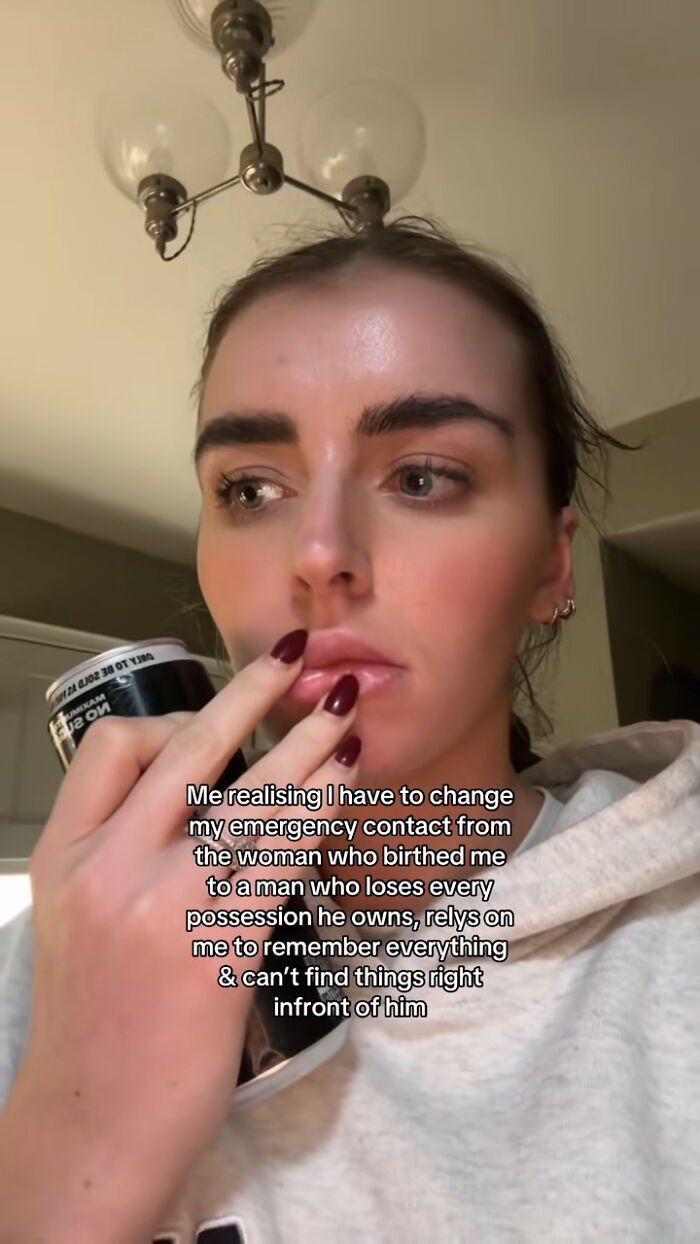 Woman in contemplation, touching lips, pondering on changing emergency contact.