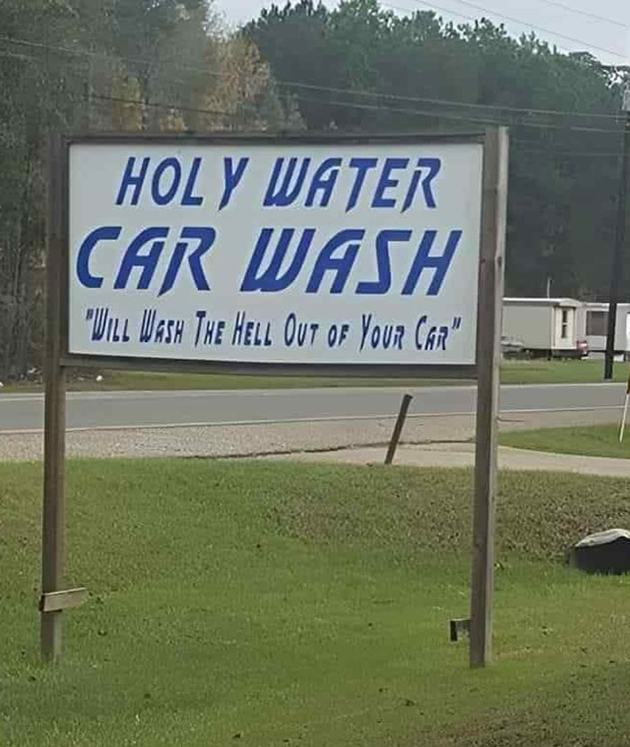 Funny sign for "Holy Water Car Wash" with humorous slogan about washing your car.