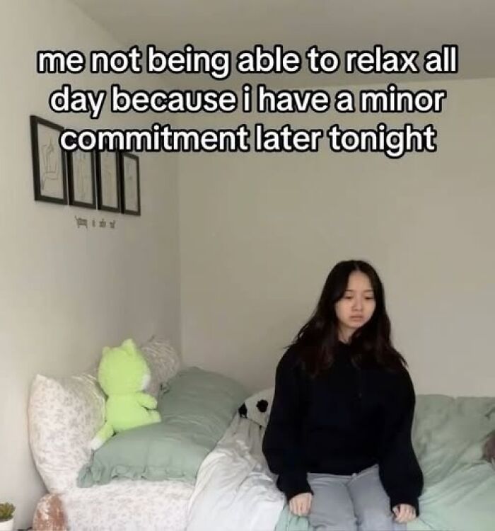 Person sitting on a bed, looking stressed with a humorous caption above, illustrating funny silly Facebook memes.