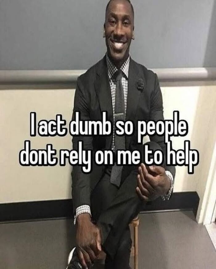 Man in a suit sitting and smiling with humorous caption about acting silly.