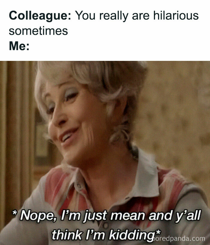 A woman with a smirk, reacting humorously to a colleague's remark.