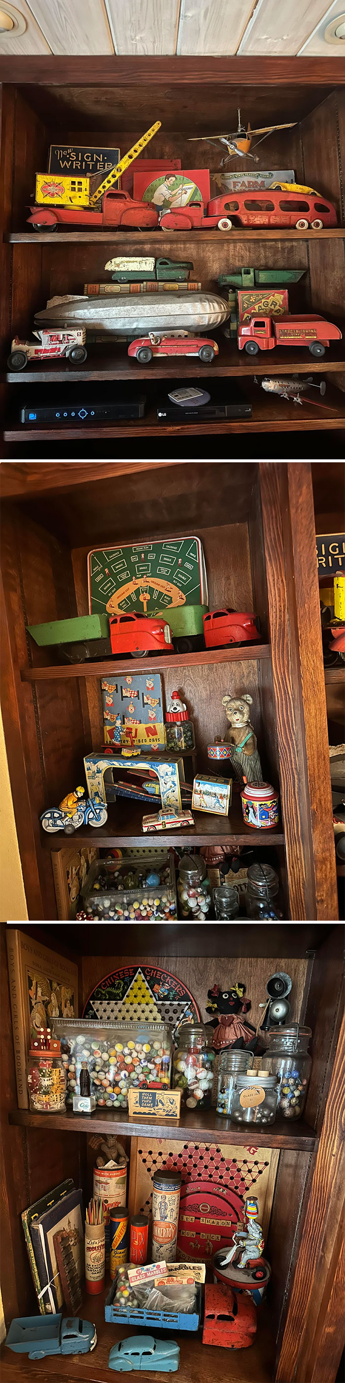 A collection of vintage toys displayed on wooden shelves, featuring colorful cars, marbles, and tin containers.