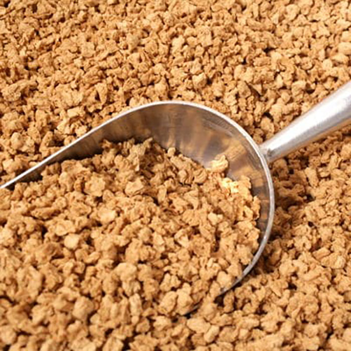 Metal scoop in bulk dry soy protein, illustrating grocery-shopping-hacks for bulk buying.