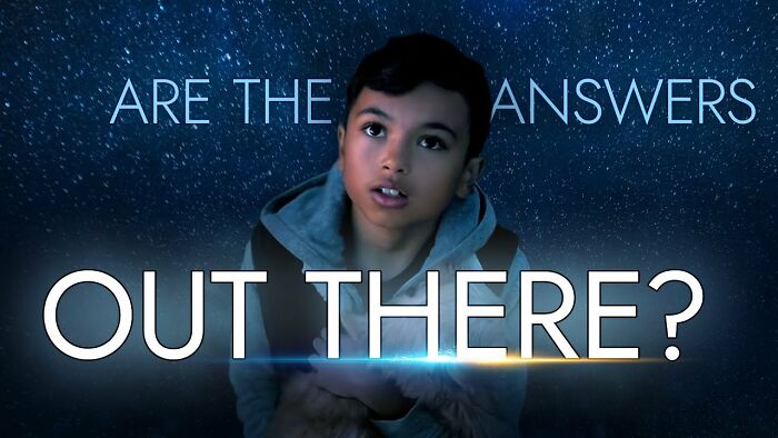A child gazing upwards with text overlay: "Are the answers out there?" in a cosmic-themed background.