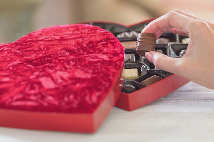 Heart-shaped chocolate box, a simple Valentine's gift idea being opened.