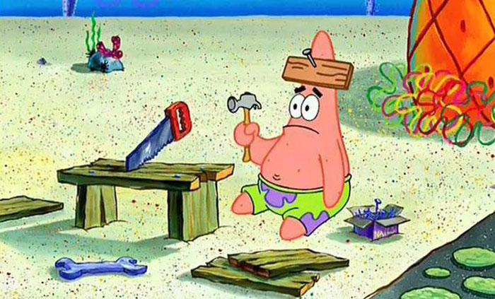 Cartoon character Patrick with a wooden plank on his head, holding a hammer, illustrating harsh realities about life.