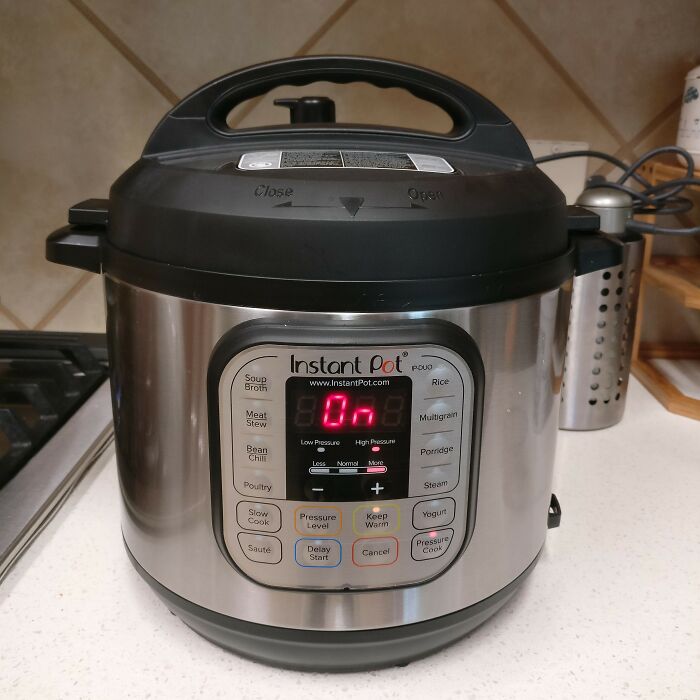 Multi-functional instant pot on a kitchen countertop, showcasing its versatile cooking settings for a minimalist lifestyle.