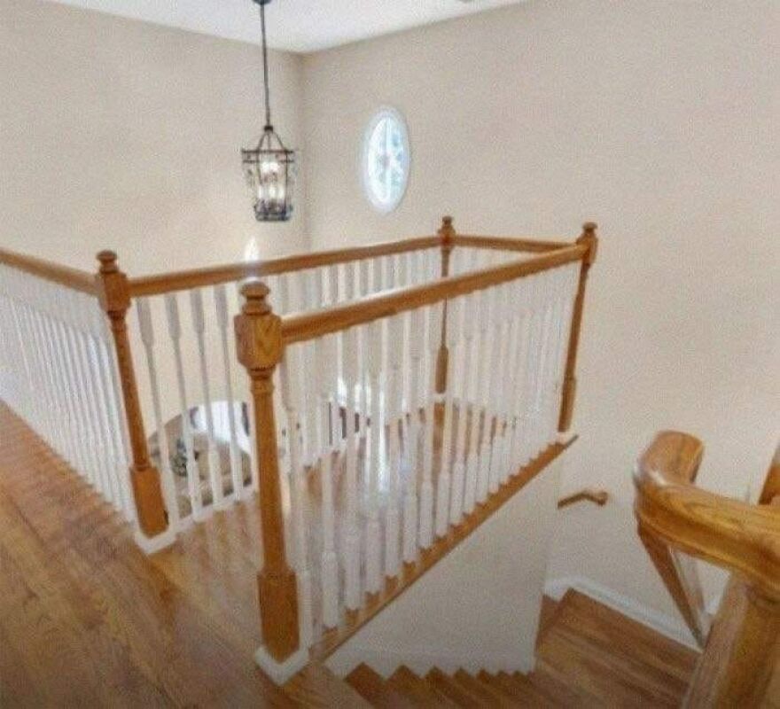 Confusing architecture with a railing blocking stairway access, showcasing poor design choices.