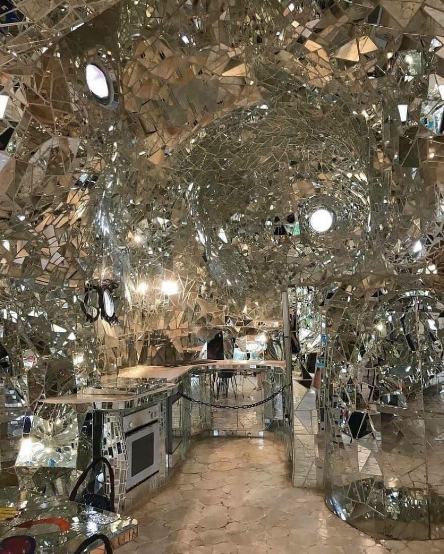 A room full of reflective surfaces and chaotic, mirrored architecture.