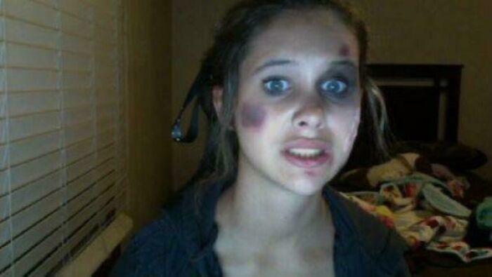 Young woman with a surprised expression and makeup resembling bruises, representing hilarious misunderstandings.