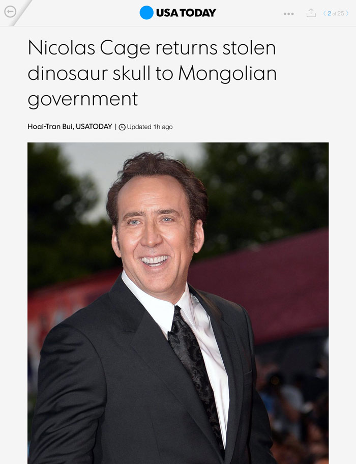 Smiling man in a suit at an event, related to hilarious news headlines about a dinosaur skull.
