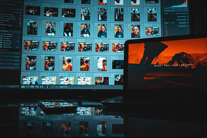 Photos of numerous people displayed on a computer screen, reflecting intense photo collection activity.