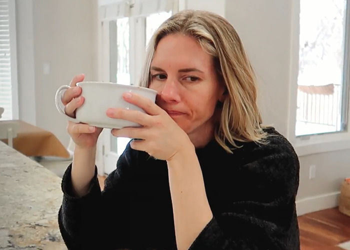 Ruby drinking from a large mug in a kitchen setting. Ruby drinking from a large mug in a kitchen setting.