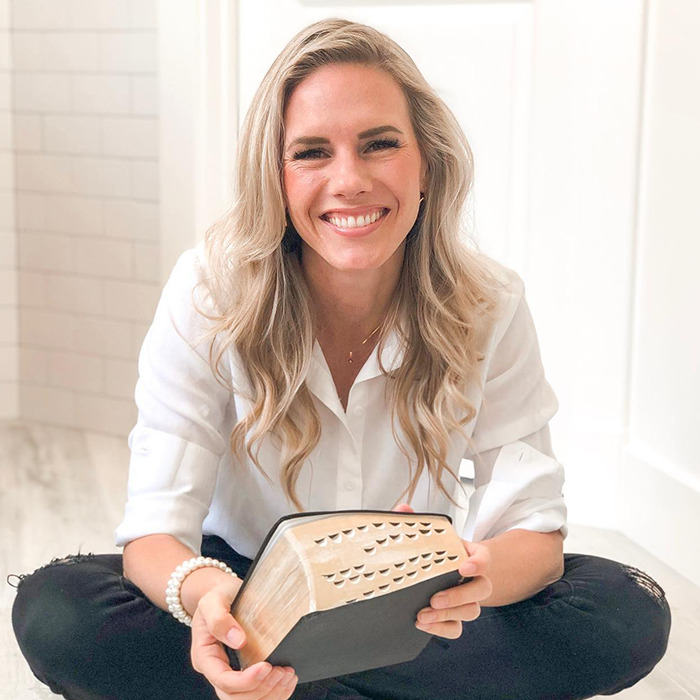Ruby Franke smiling while sitting, holding a book. Ruby Franke smiling while sitting, holding a book.