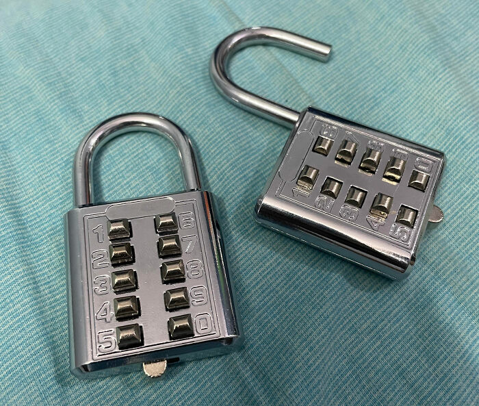 Two metal combination locks on a teal fabric, symbolizing bizarre secrets.