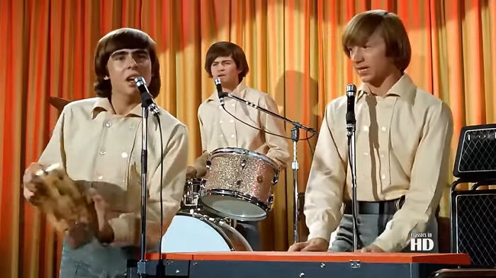 Musicians in beige shirts performing on stage, related to bizarre facts.