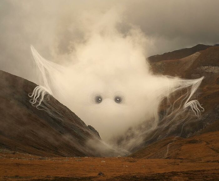 Misty landscape with a cloud shaped like a creature, artwork by Vorja Sánchez, emphasizing interventions in nature.