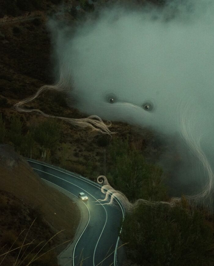 Abstract creature in fog above winding road at night, part of "Interventions" series by Vorja Sánchez.