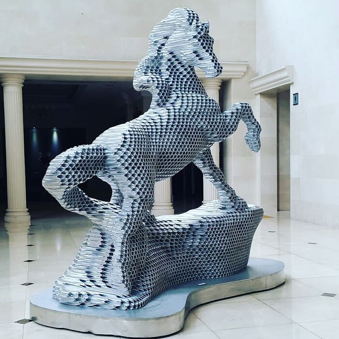 Metal pipe sculpture of a rearing horse by Yi Chul Hee, displayed indoors.