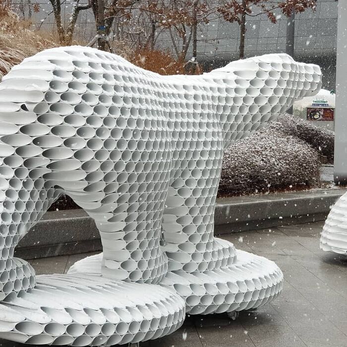 Metal pipe sculpture of a bear in a snowy outdoor setting by Yi Chul Hee.