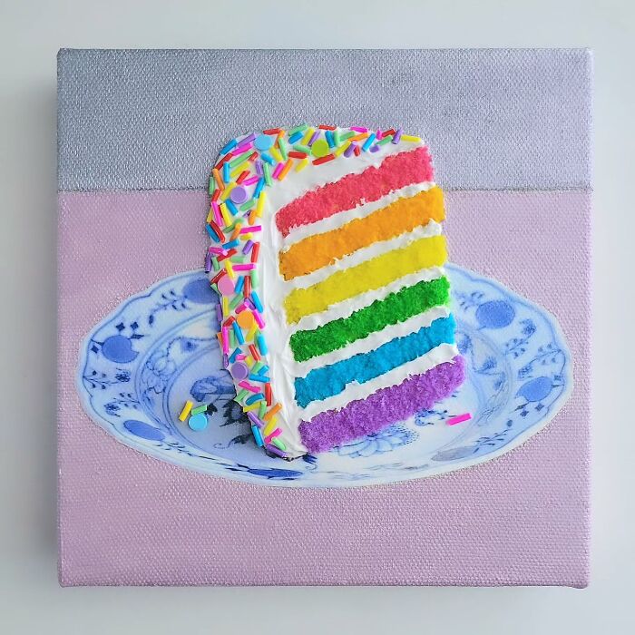 Hyper-realistic embroidered dessert art depicting a colorful rainbow cake slice with sprinkles on a decorative plate.
