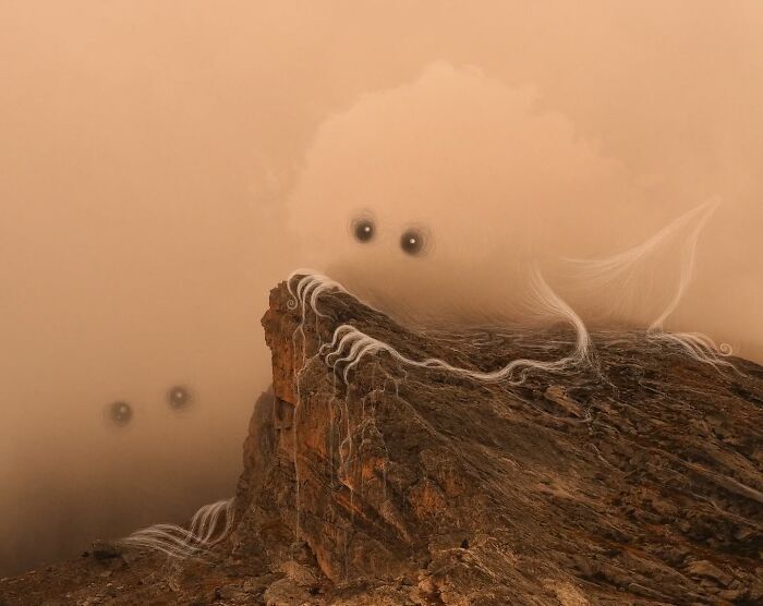 Whimsical creature with wispy lines on a rocky cliff, part of Vorja Sánchez's "Interventions" series.