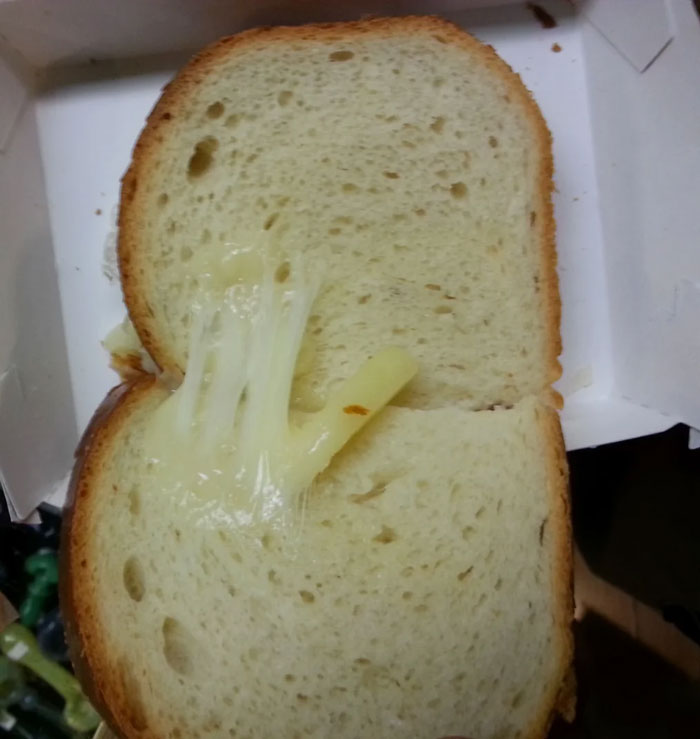 Sparse cheese on a sandwich highlights common food scams.