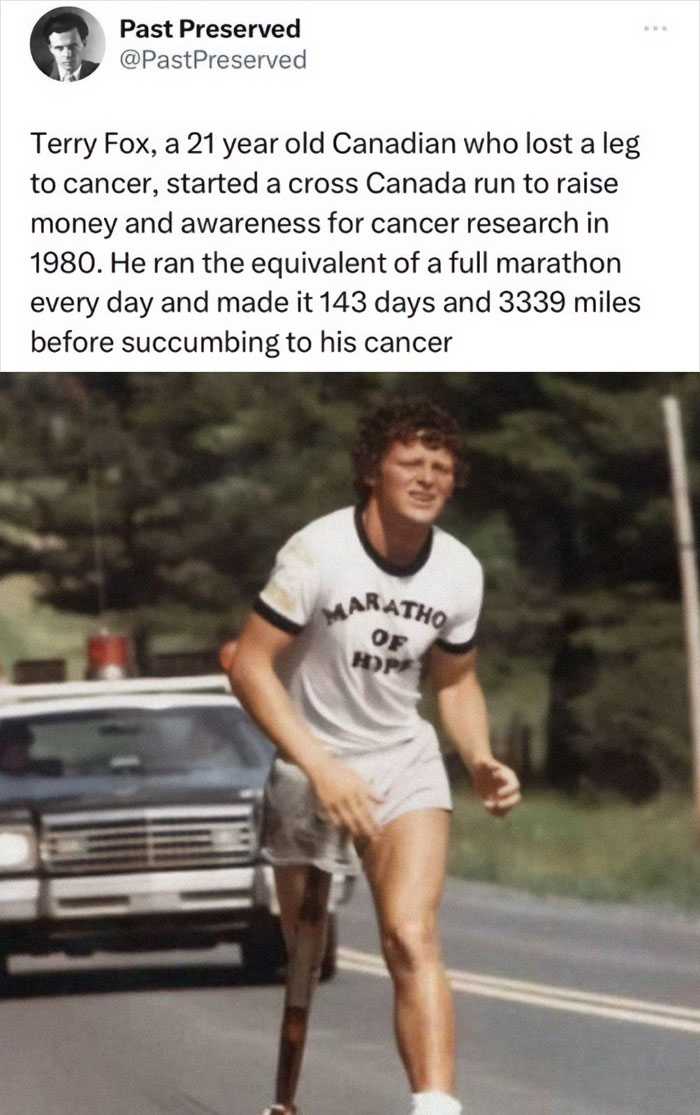 Man running with a prosthetic leg during a historic cross-country marathon, police car in the background.