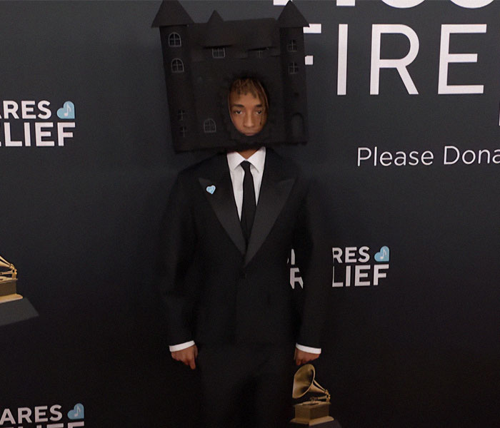 Man wearing a unique outfit resembling a house structure at the 2025 Grammy Awards.