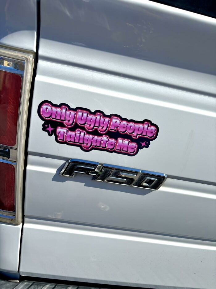 Sticker on a white truck reads "Only Ugly People Tailgate Me," representing relatable girly humor.