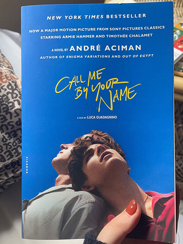 "Cover of the book 'Call Me by Your Name' featuring two people against a blue sky, showcasing a notable book quote."
