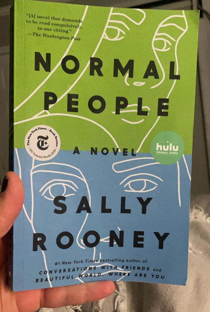 Cover of "Normal People" by Sally Rooney, a notable book featuring appealing quotes, held in someone's hand.